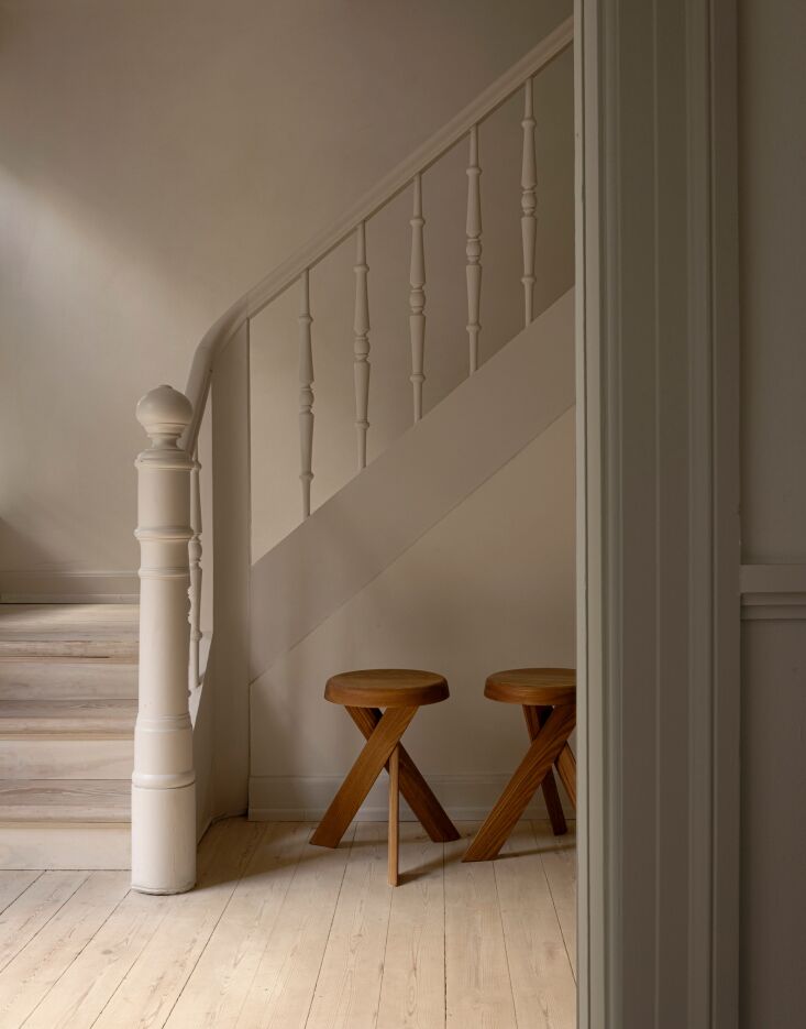 a pair of vintage \1980s pierre chapo stools at the entryway. 19