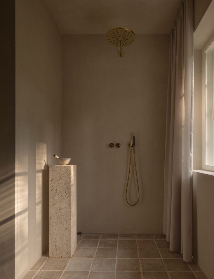a stone inflected shower with a vola shower mixer. 32
