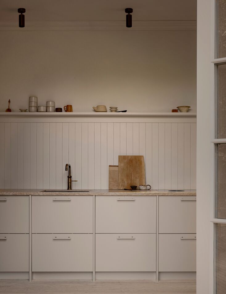 the kitchen is designed with italian limestone countertops with a bush hammered 24