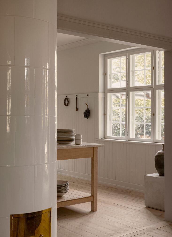 the living room is separated from the kitchen by a newly built swedish tiled st 23