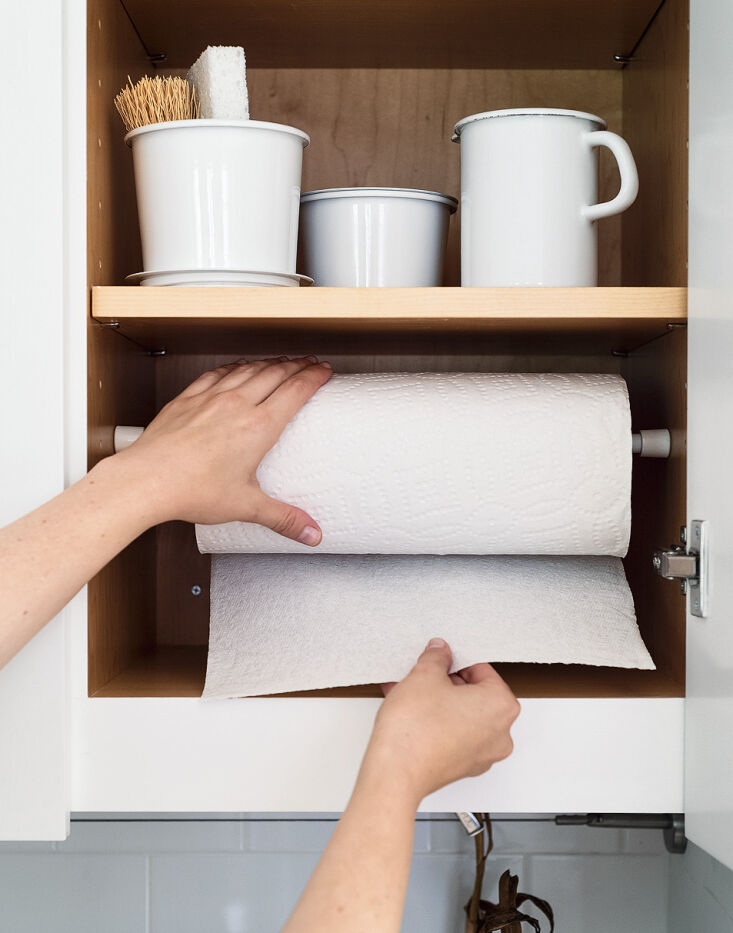 a tension rod keeps paper towels off the counter and at the ready. 19