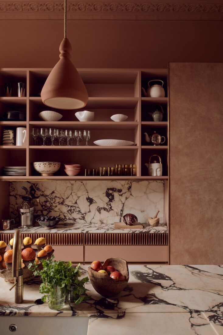 richly veined marble and a band of wooden cigar molds add pattern and texture t 19