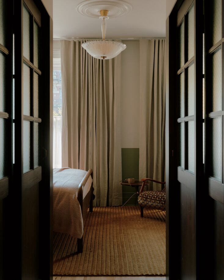 upstairs are a guest room and the primary bedroom, shown here. a mid century or 25