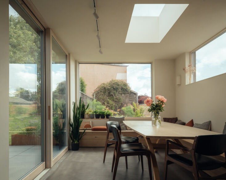 large sliding doors open into the dining area, where cleverly placed glazing an 19