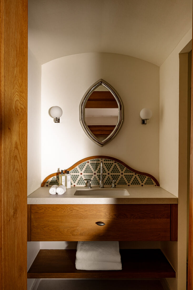 behind the sink, tiny hexagonal tiles are arranged in a geometric pattern for v 25