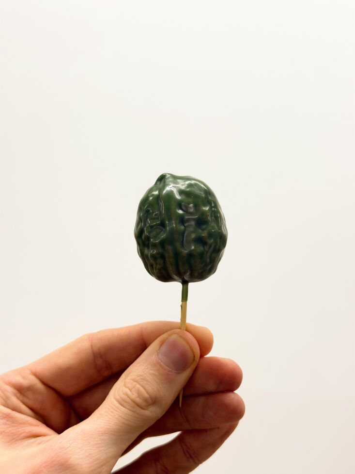 walnut shells are hand dipped in colorful wax using a single toothpick. 23