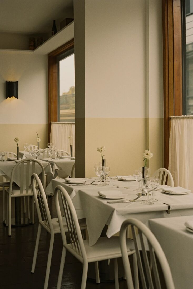 walls are two toned in white and cream with cafe curtains in every window. 18