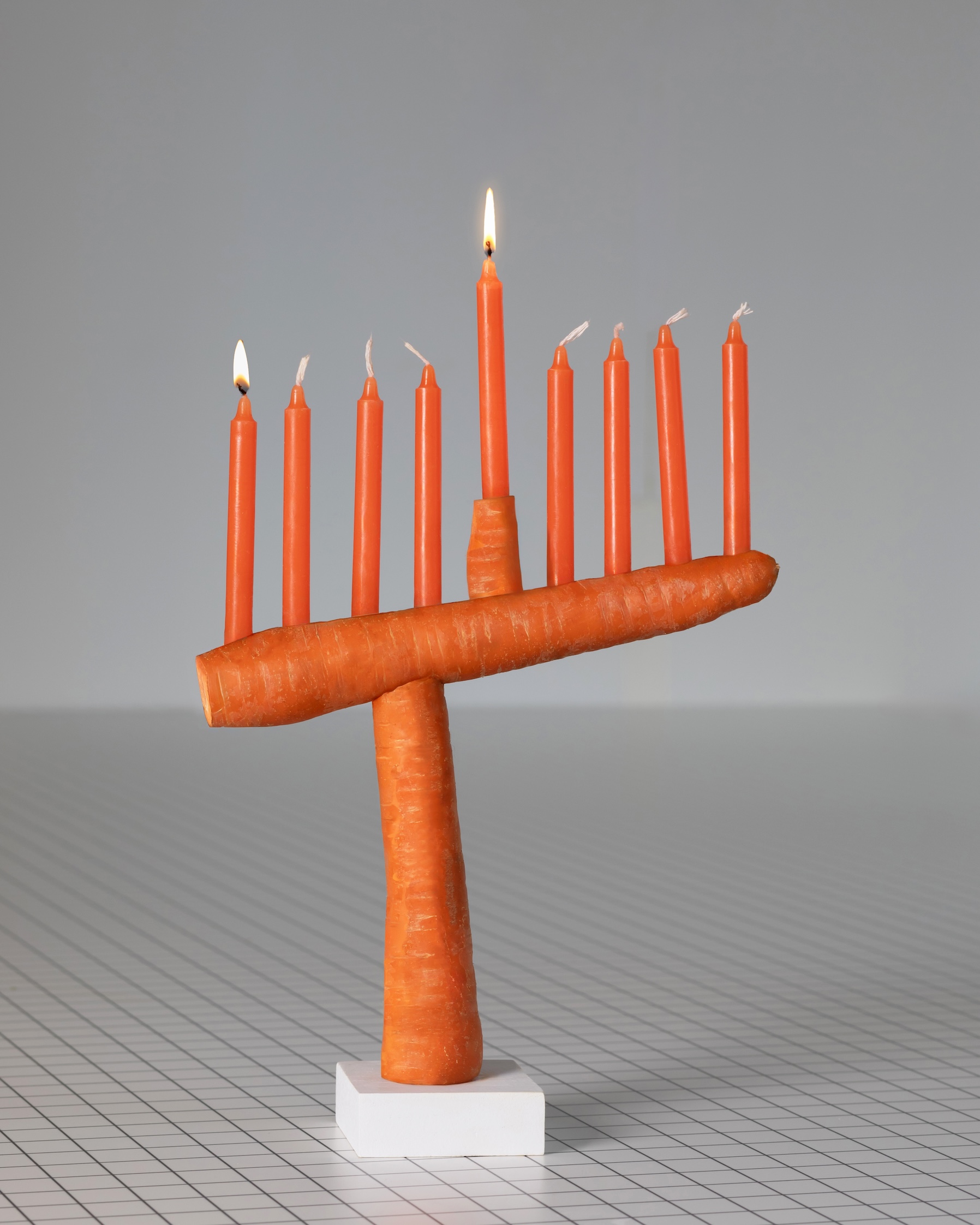 this sculptural carrot menorah is balanced thanks to a hidden metal t shaped ar 19