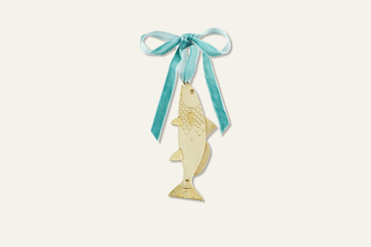 we have a thing for fish motifs—and this polished brass ornament comes engrav 18