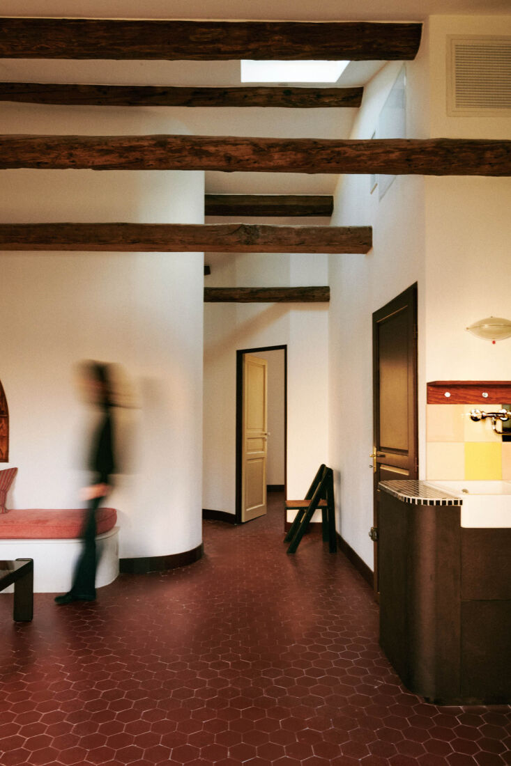 the front door to the attic opens to a living area and kitchen with tall ceilin 17
