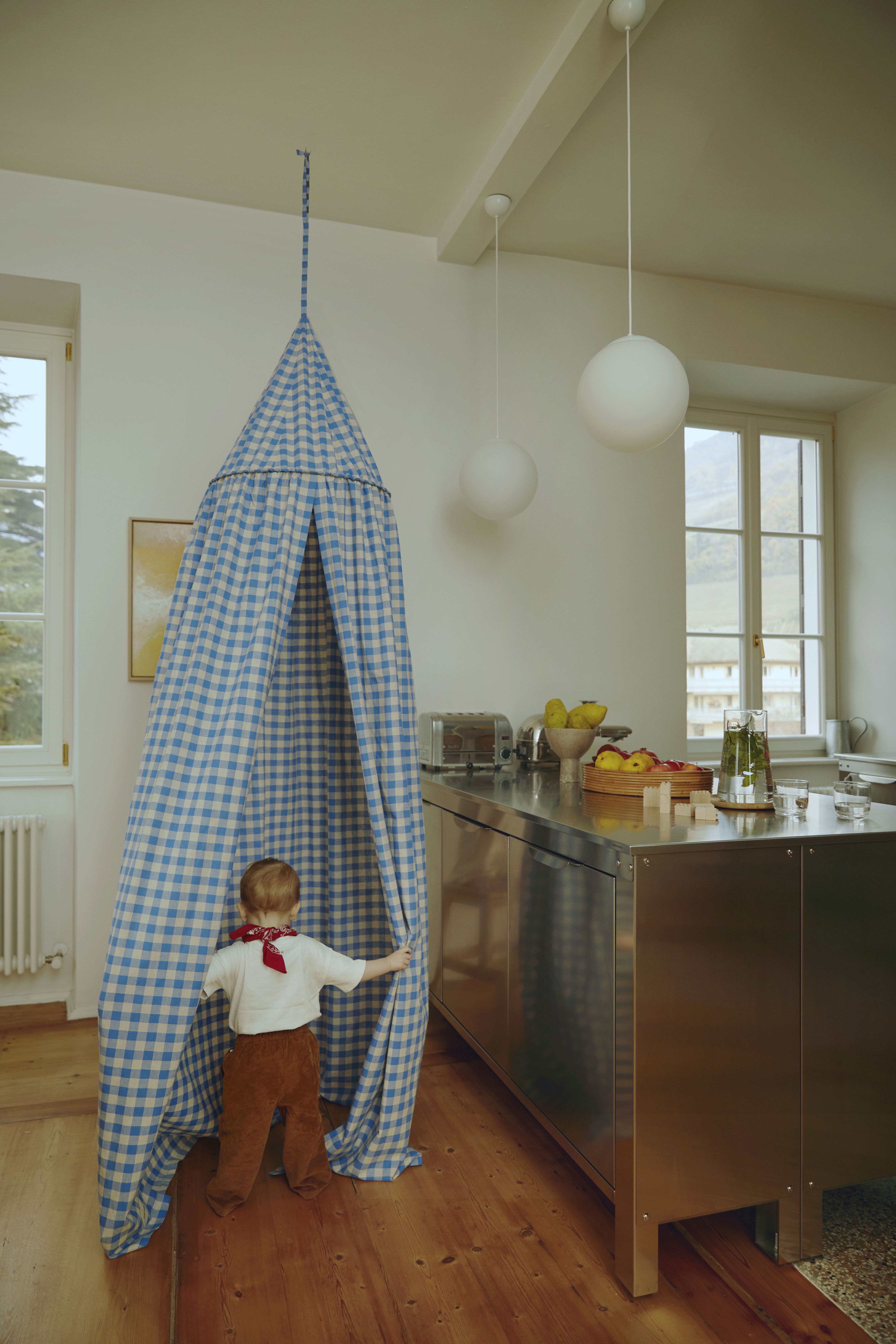 hanging near the kitchen is a bed canopy from minor things for an instant toddl 21