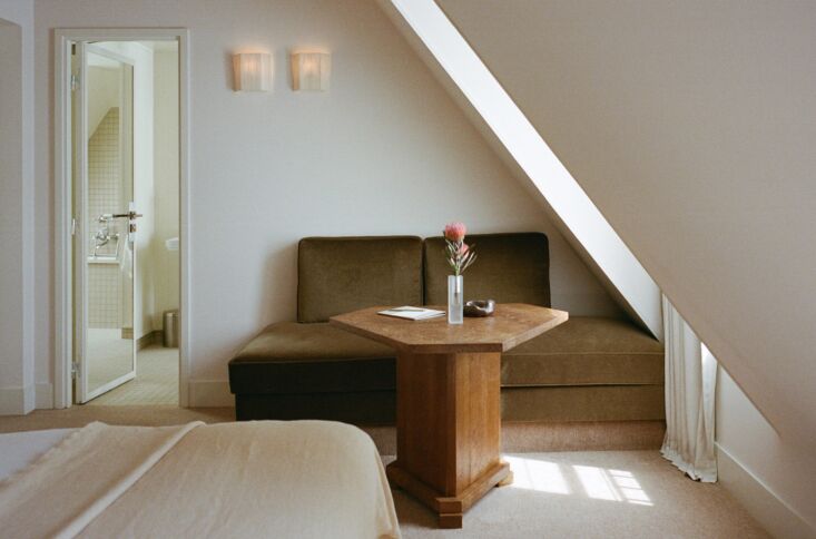 velvet seating, an alexis mazin table, and pair of vintage sconces arranged tog 29
