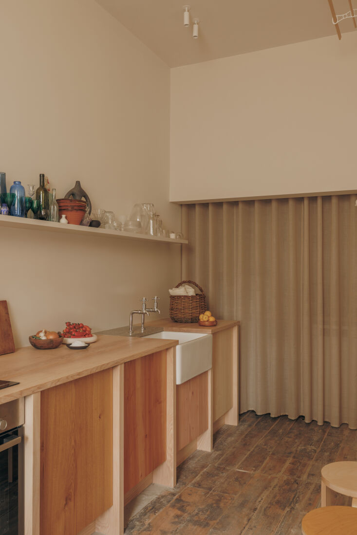 alexander eschewed upper cabinets in favor of a single floating shelf that disp 21