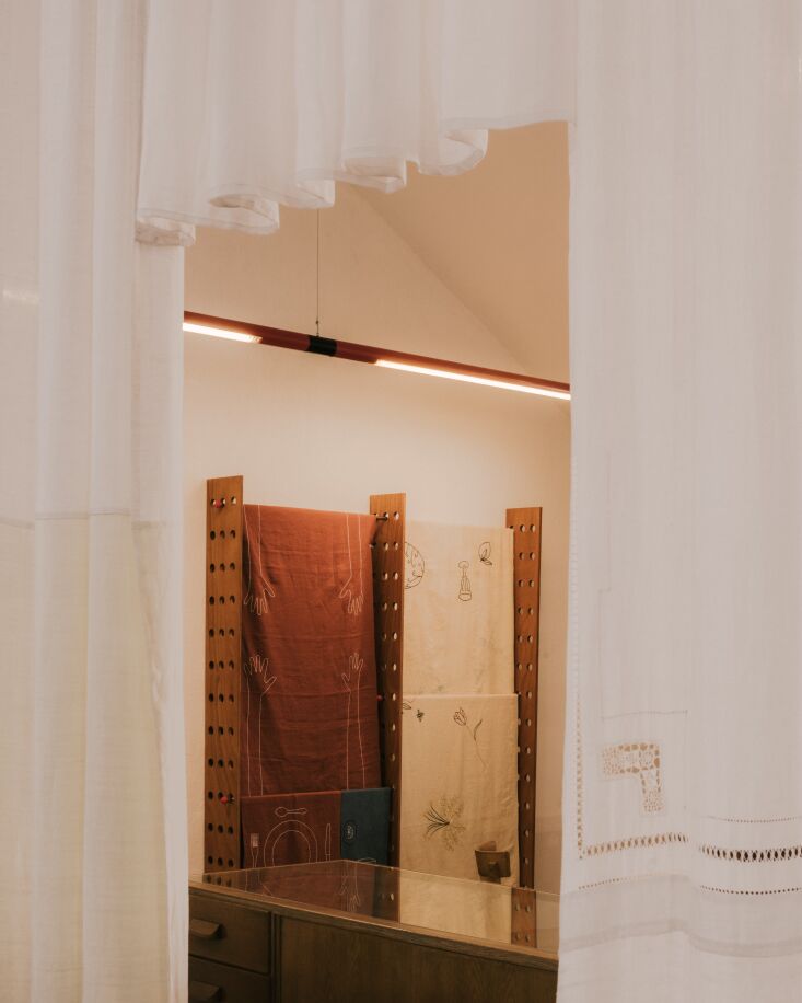 a look into the showroom from the office/atelier space behind a custom patchwor 32