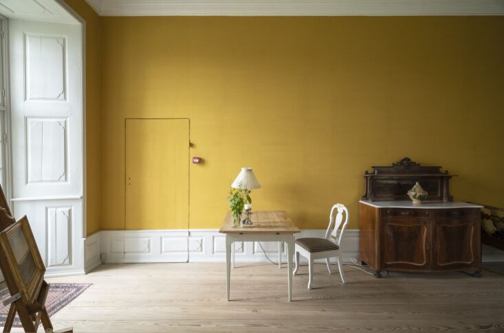a bold custom shade of yellow was applied to this bedroom wall. a similar shade 27
