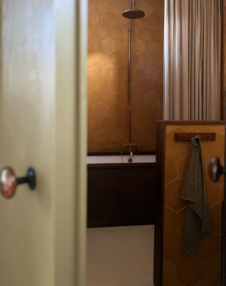 the warmth of wood and mustard awaits in this cleverly remodeled bathroom featu 20