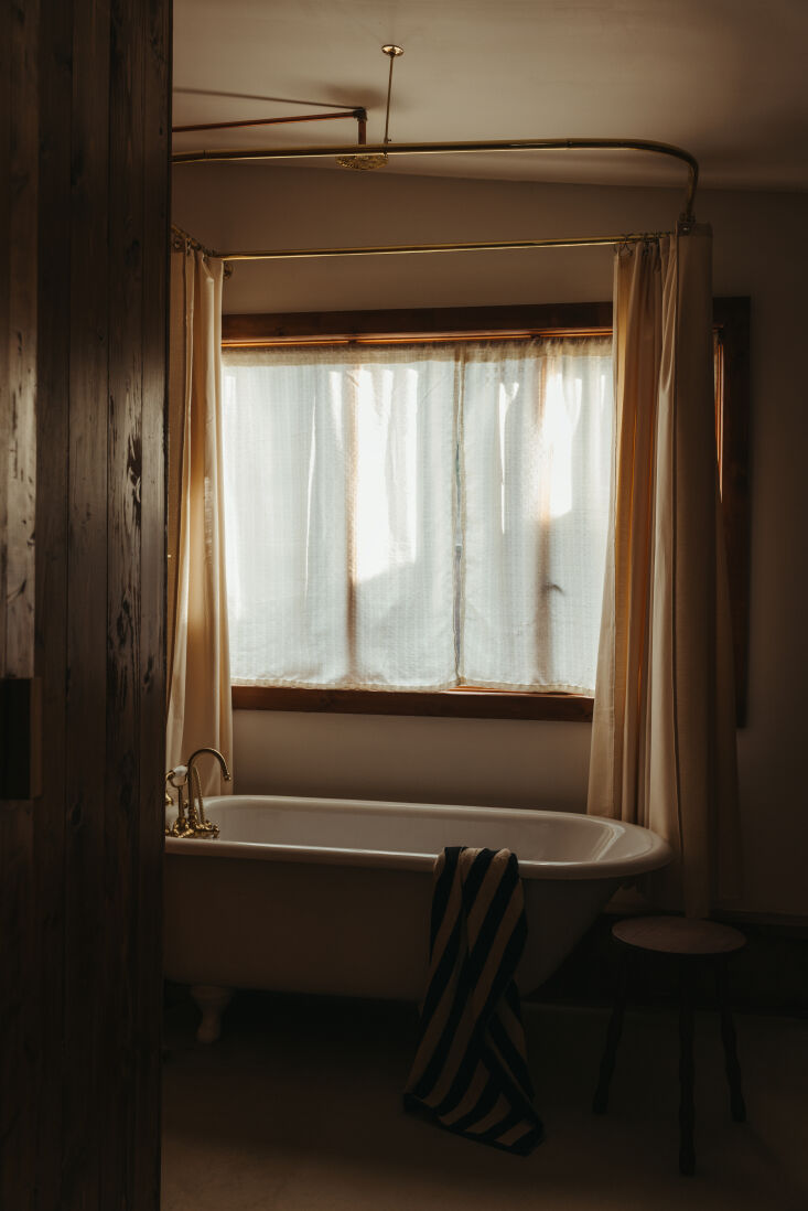 the cast iron tub is a century old, salvaged from the same farm as the bathroom 26