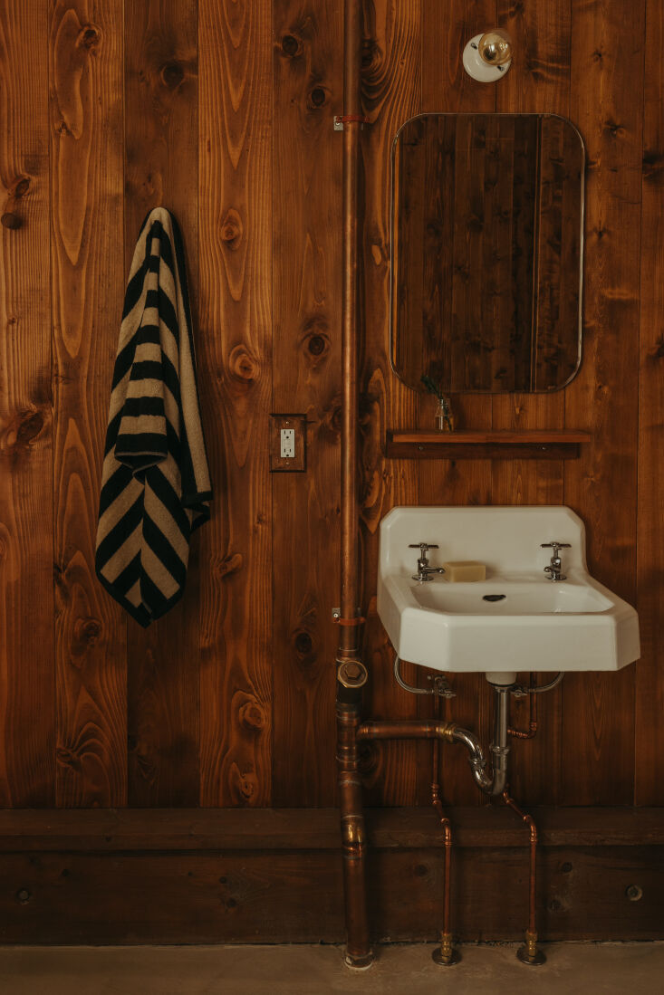 in the bathroom, the walls are tongue and groove cedar, and the sink came from  25