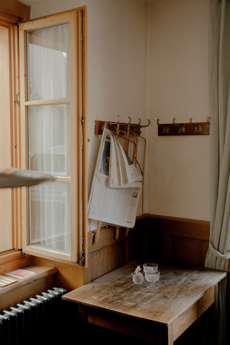 newspaper holders hang on corner coat racks. 27