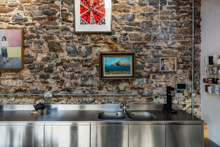 a row of stainless steel cabinets make up the kitchen. (see kitchen(s) of the  19