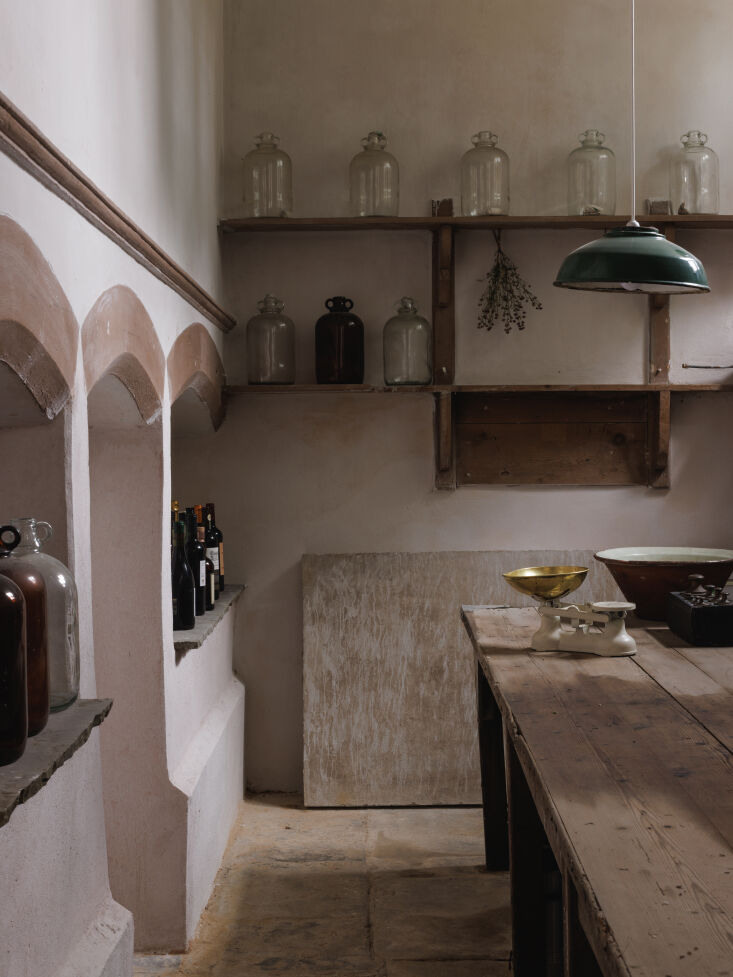 the step down dairy now serves as pantry filled with kilner jars and demijohns. 22