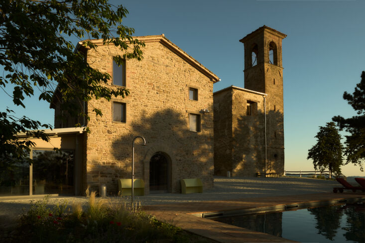 outside of the locanda scavolo is the scavolo pool, an arch shaped pool with a  28