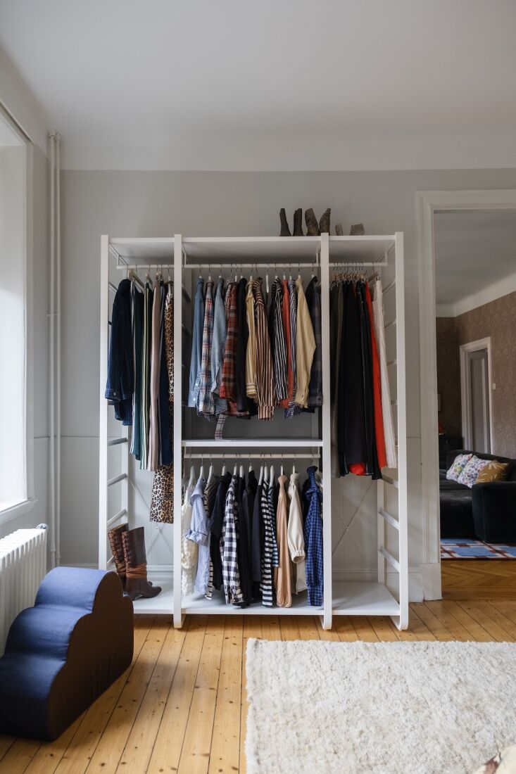 elisabeth hangs clothes that are in heavy rotation in an ikea elvarli open clos 28