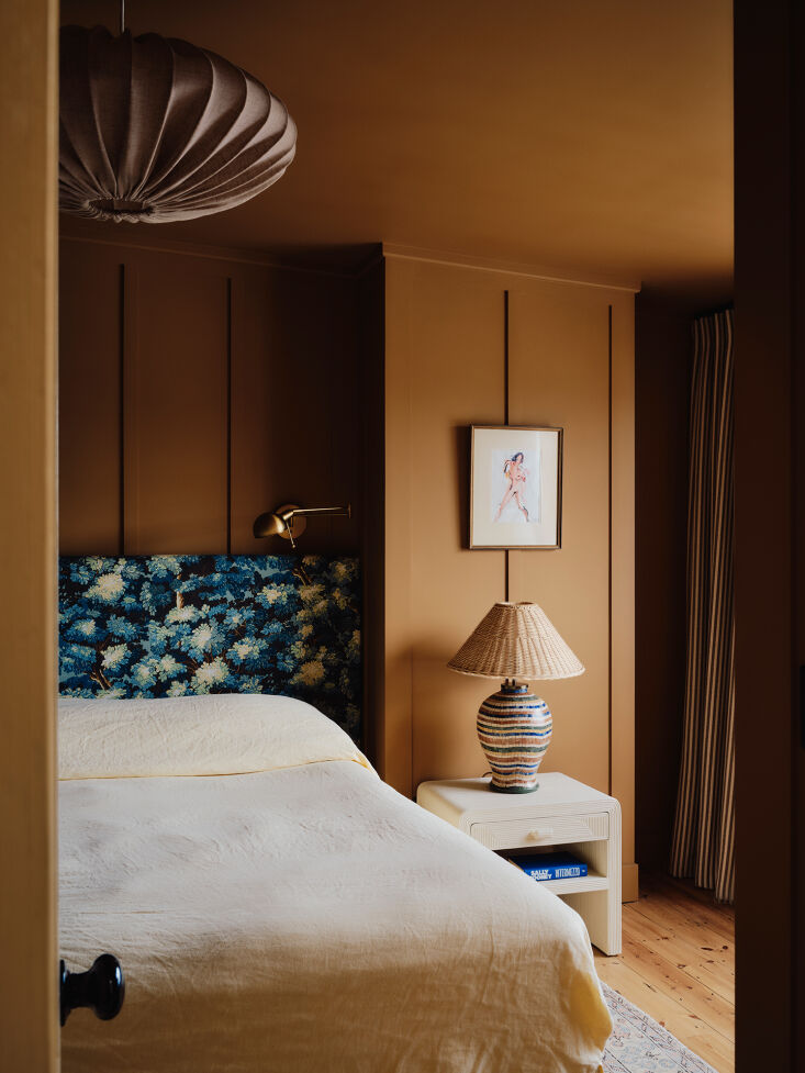 the walls in the main bedroom are painted a more muted color: little greene&amp 24