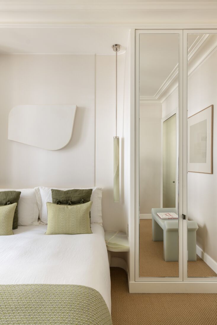 in the bedroom, a curved niche frames the bed. green onyx bedside tables and a  28