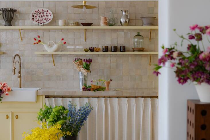 soft yellow suits the cabinetry at this flower filled space: house of three: ny 24