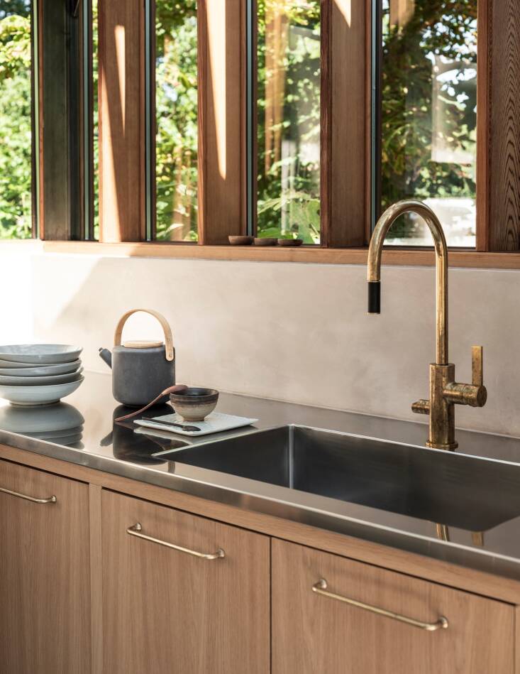 light oak cabinets, antique brass hardware by corston, and a brass faucet by ta 23