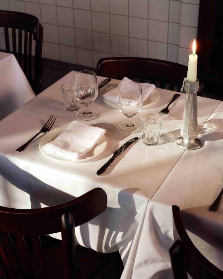 a simple table setting with aluminum candle holders. 19