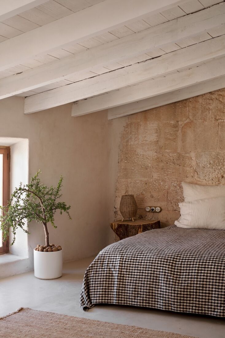 the guest room\2\17;s pitted limestone wall was preserved as is. the cot 28