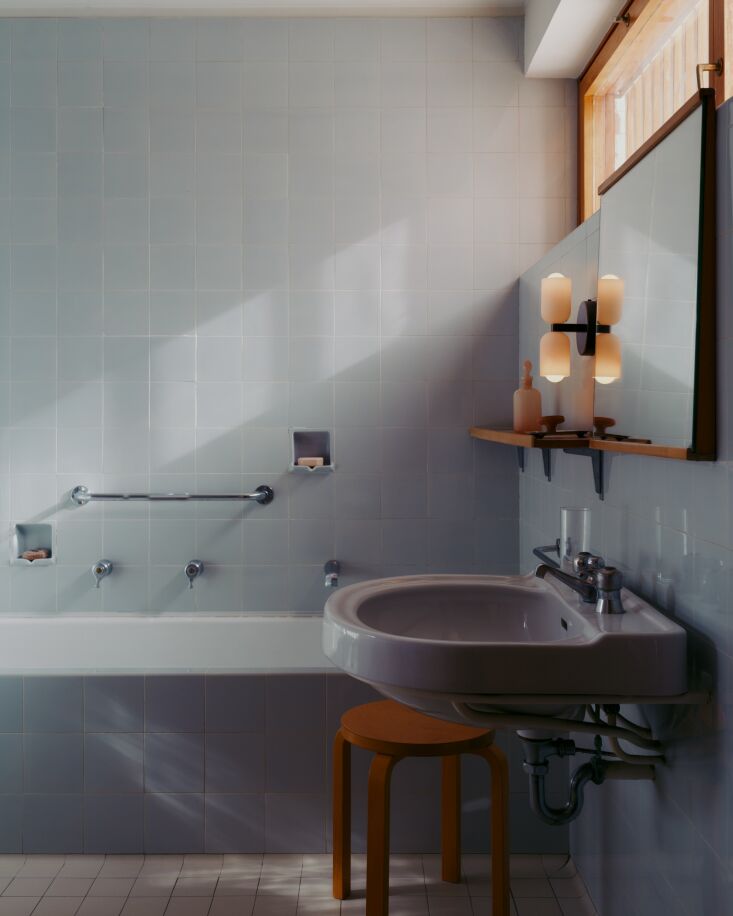 the original pale blue tiled bathroom with the chromatic glass up down sconce. 27