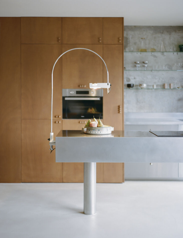 the lamp is a joe colombo spider arc lamp from \1967. the cabinets are okoumé 19