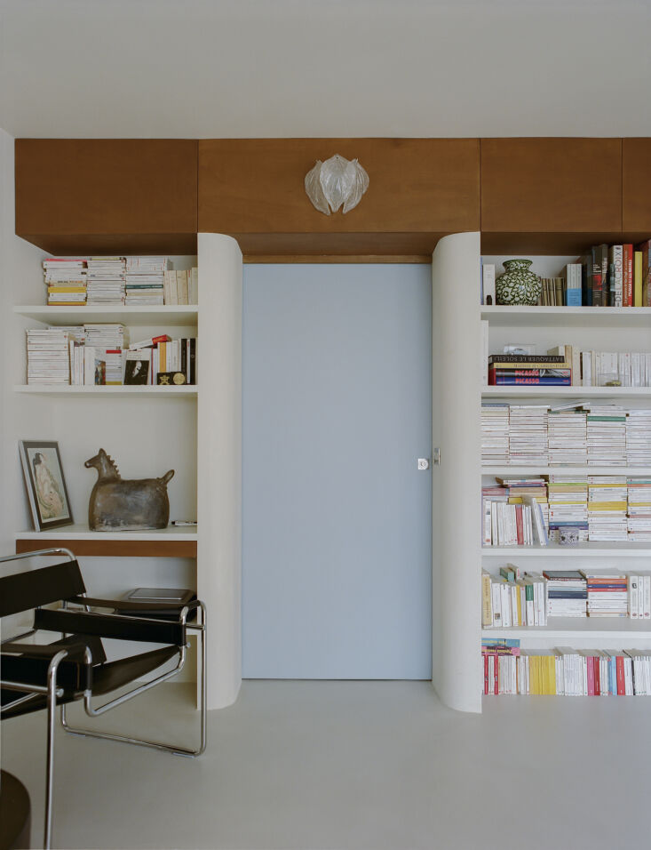 bedrooms are closed off with custom pocket doors in pale blue. 24