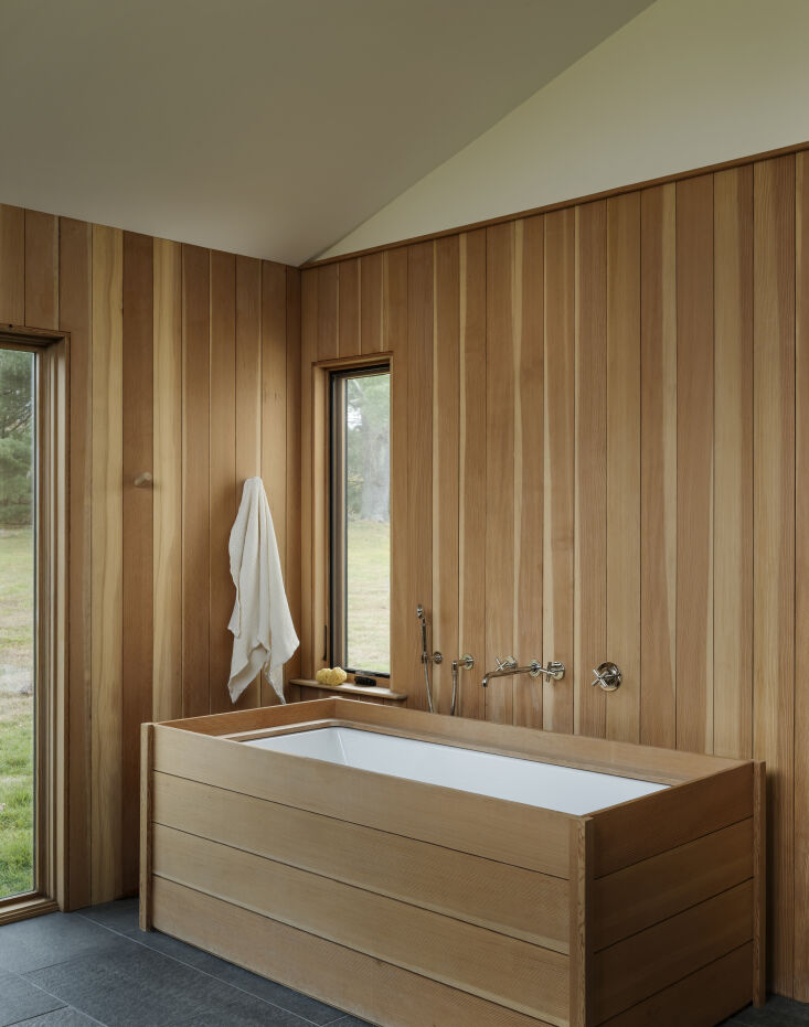 the architects clad the primary bath in clear cedar and built a custom cedar en 26