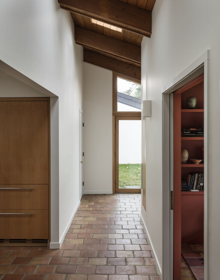 a saltillo tiled mudroom hall leads into the kitchen and media room (which is p 25