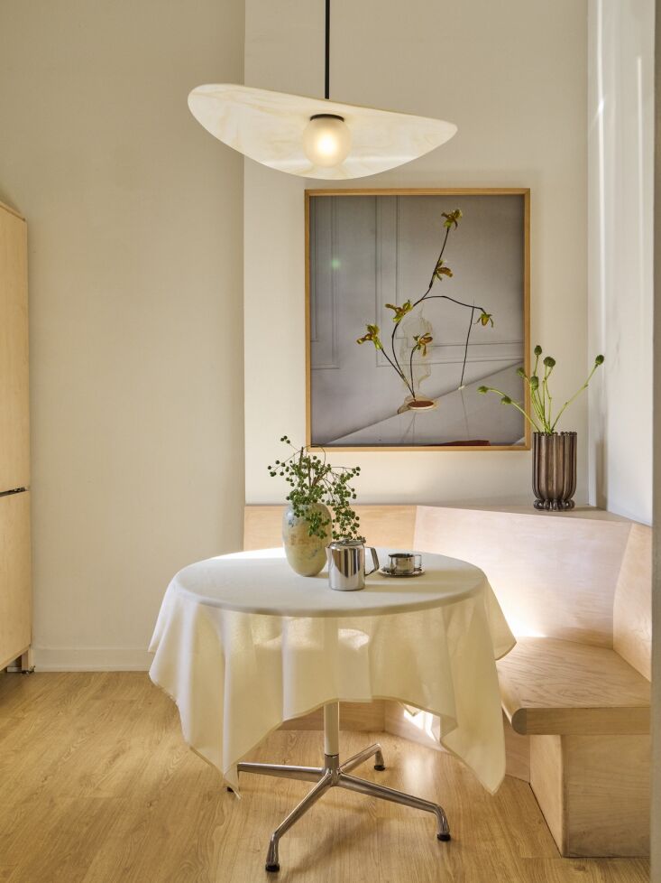the kitchen came with its banquette, which is accessorized with work by hello h 22