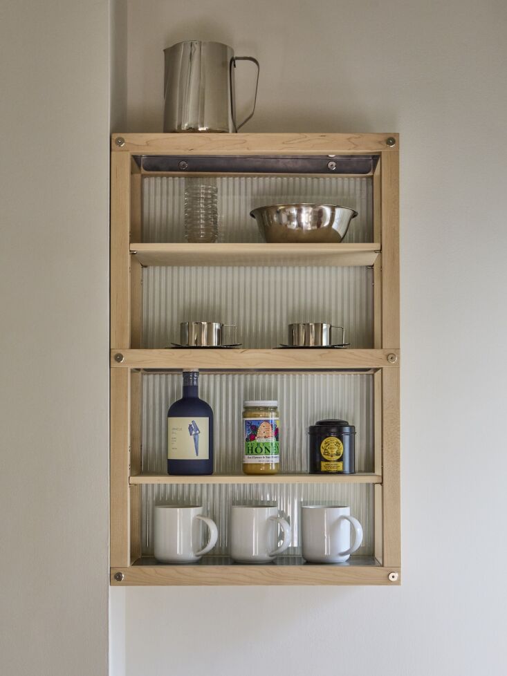 the hanging shelves are maple with nickel hardware and fluted glass. photograph 23