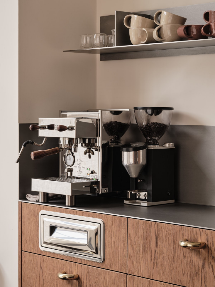 integrated into the cabinet below the coffee area is a stainless steel compost 18