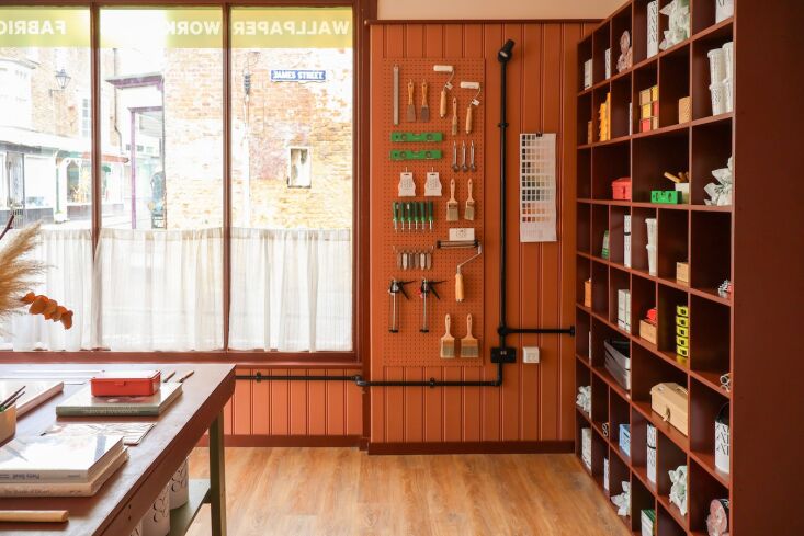 emma built the storage and counters herself. she singles out the large wall she 25