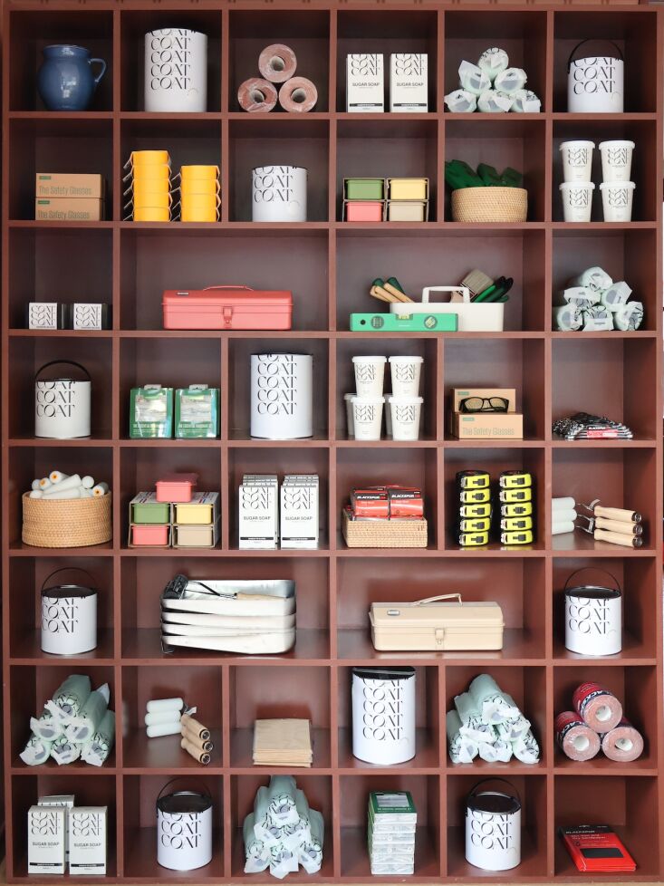 emma built the storage and counters herself. she singles out the large wall she 26