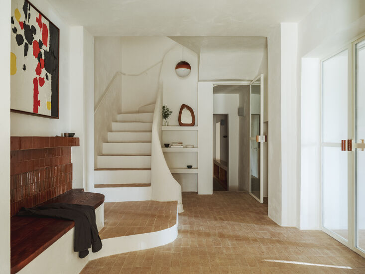 a curved staircase and natural stone floors made in collaboration with btp pres 24
