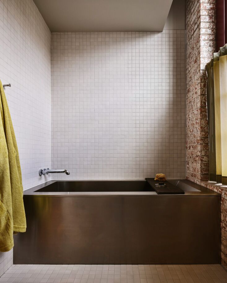 in the bath, bathrobes by eckhaus latta and polished chrome fixtures. 24