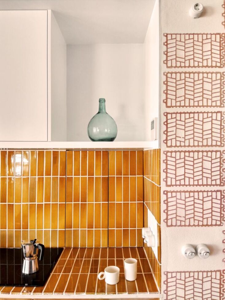 vertical stacks of glazed subway tiles appear inside and out in spots that call 21