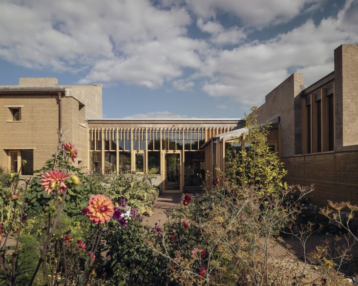 the two main rammed earth volumes are linked with a kitchen/dining pavilion fra 20