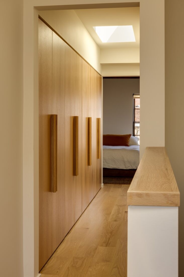 the hall outside the two upstairs bedrooms doubles as a dressing area. the cust 30