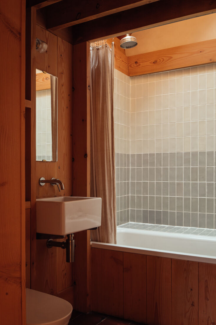 the architects designed a light well above the bath to bring verticality into t 27