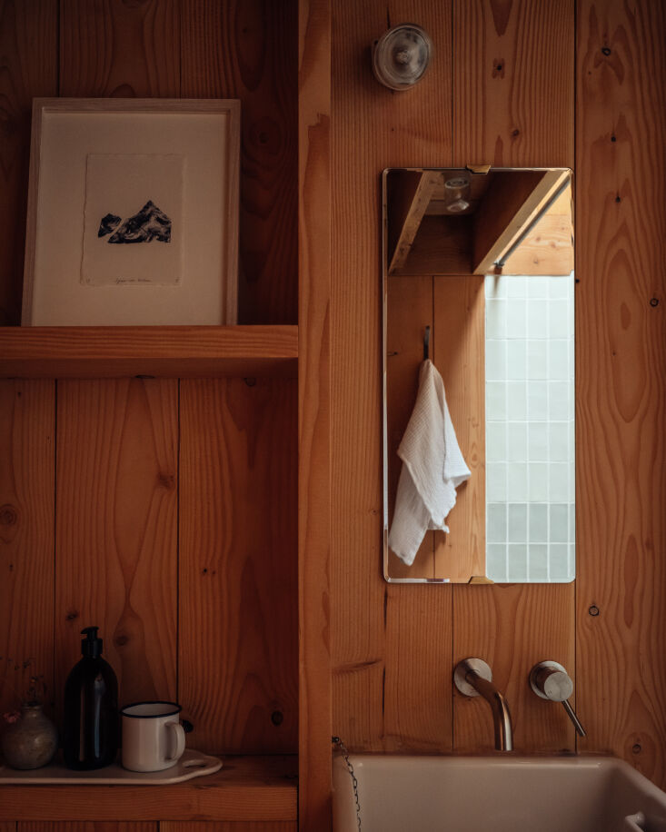the bathroom has a cabin like feel with a compact wash basin, an armitage shank 28